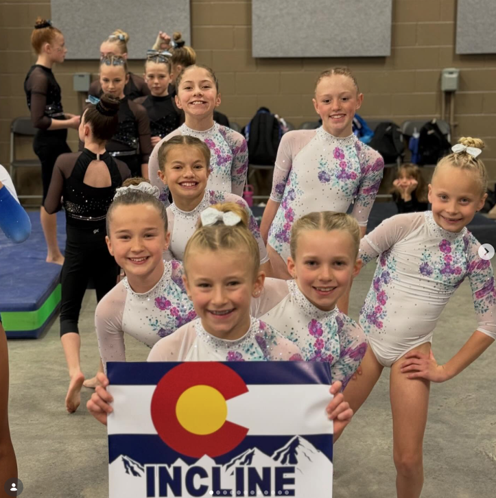 Incline Gymnastics compulsory team with Colorado banner